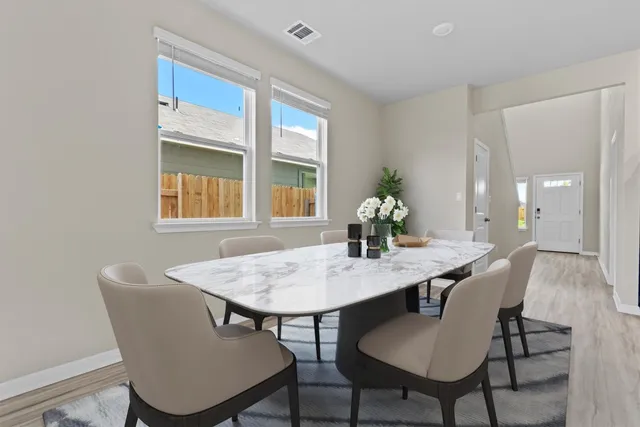 a view of a dining room with furniture and window