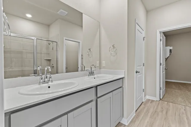 a bathroom with a sink double vanity and a mirror