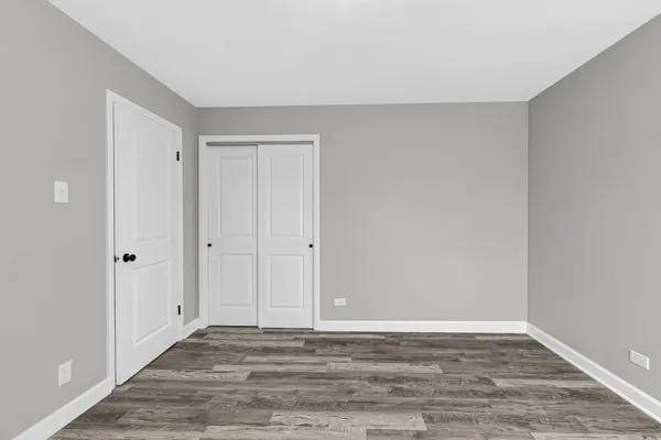 a view of an empty room and wooden floor