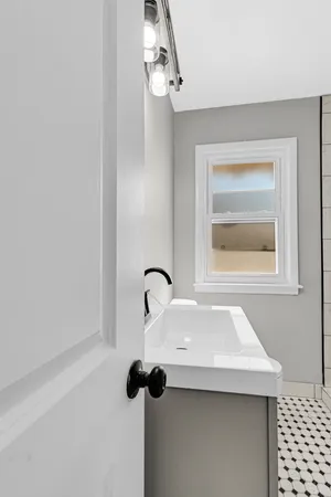 a close view of a sink a faucet and chandelier