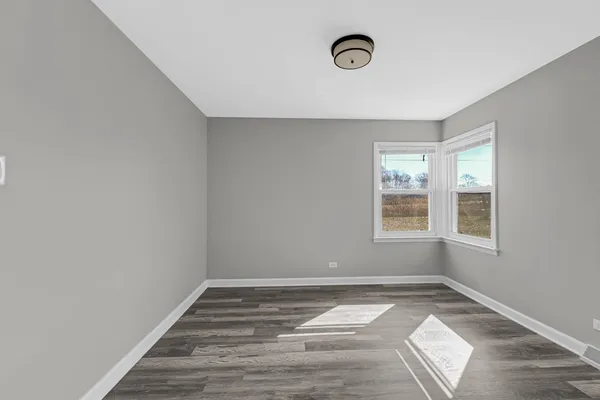 a view of a livingroom with wooden floor and window