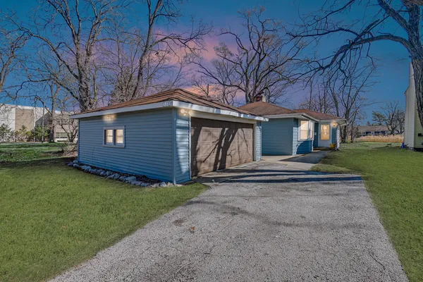 a front view of a house with a garden