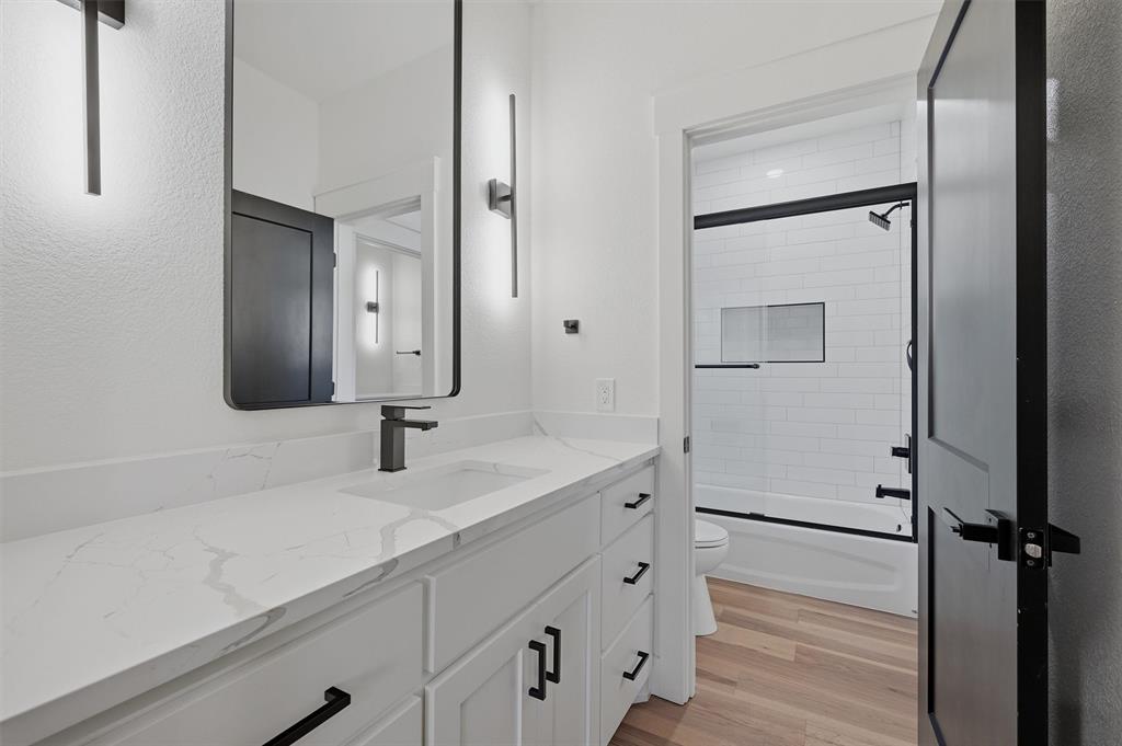 1805 Arthur Road Denison, TX 75021 - Photo 27 of 40 a bathroom with a double vanity sink mirror and toilet