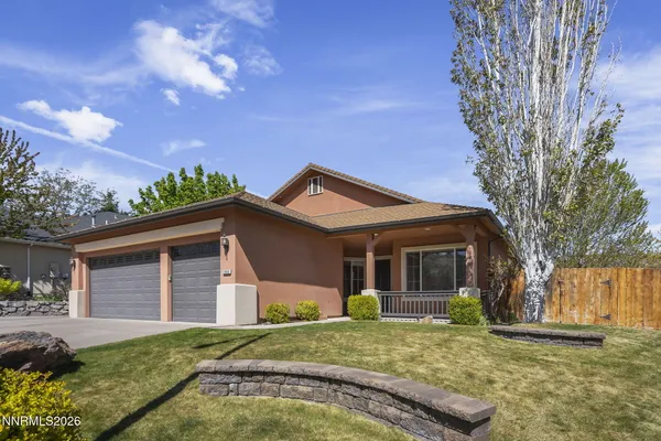 a front view of a house with a yard and garage