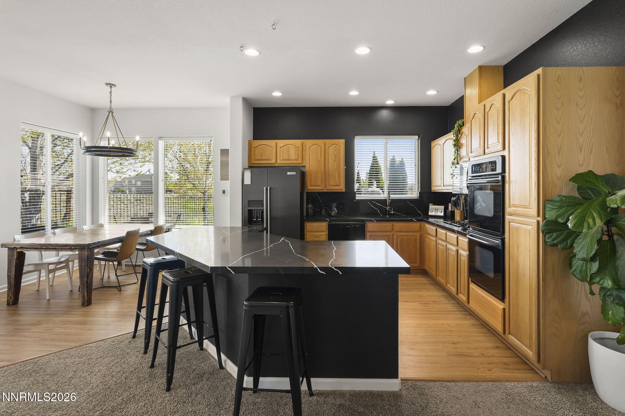 2900 Moose Ridge Drive Reno, NV 89523 - Photo 12 of 43 a kitchen with stainless steel appliances granite countertop a table chairs sink refrigerator and microwave