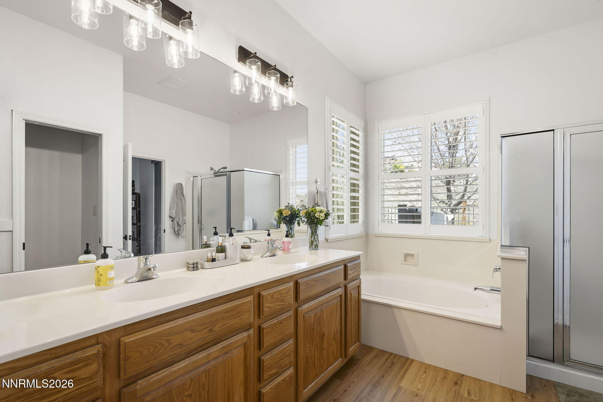 2900 Moose Ridge Drive Reno, NV 89523 - Photo 22 of 43 a bathroom with double vanity sinks a large mirror and a bathtub