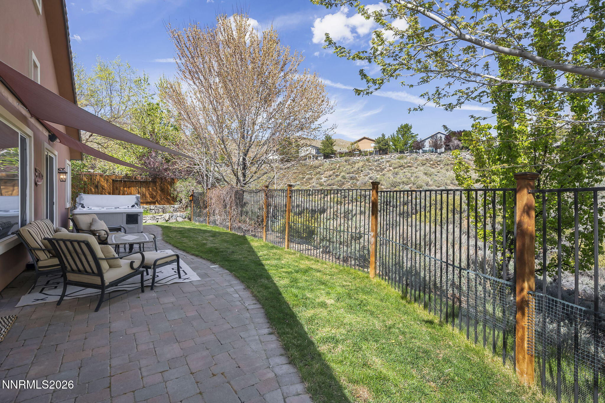 2900 Moose Ridge Drive Reno, NV 89523 - Photo 31 of 43 a view of a patio with a table and chairs and wooden fence