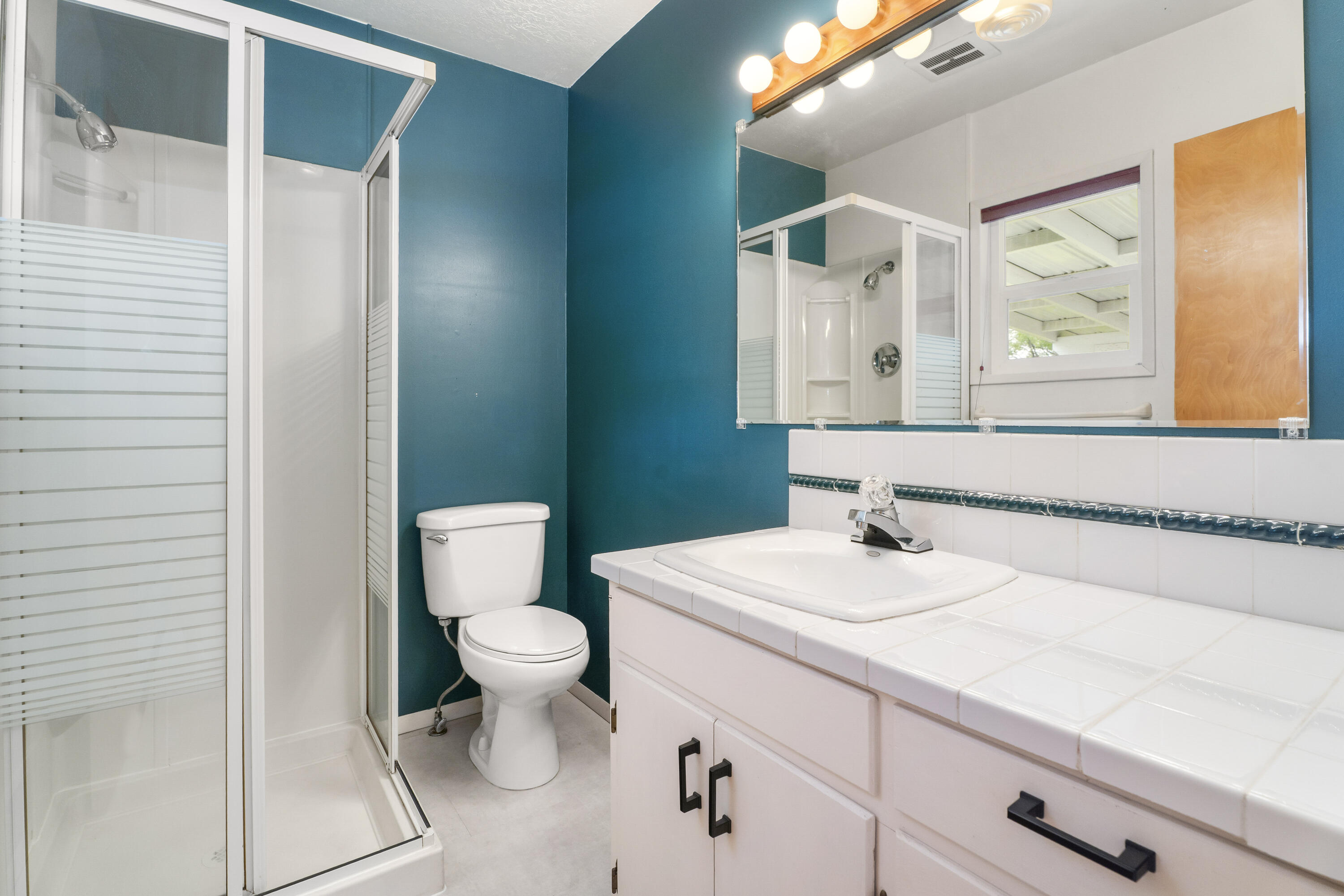 946 Southwest 13th Street Redmond, OR 97756 - Photo 21 of 49 a bathroom with a sink vanity mirror and toilet