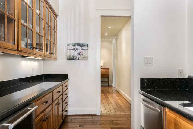 a kitchen with stainless steel appliances granite countertop a stove and a microwave