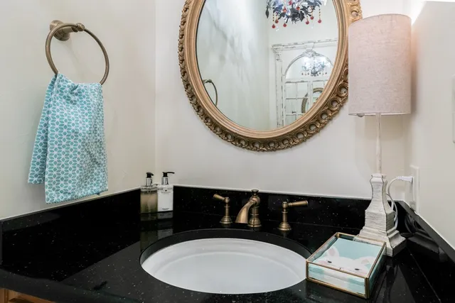 a bathroom with a sink mirror and vanity