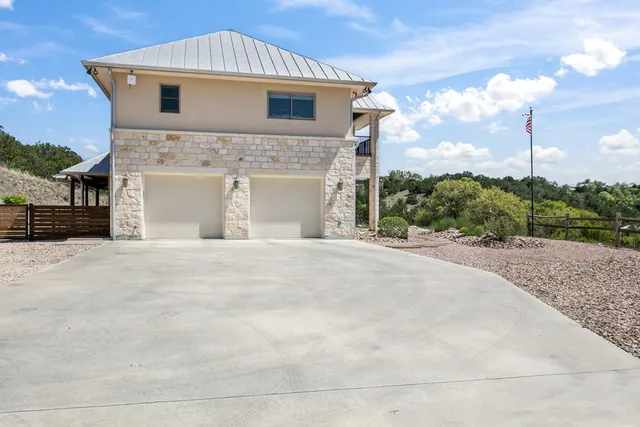 a living room with furniture wooden floor and kitchen view