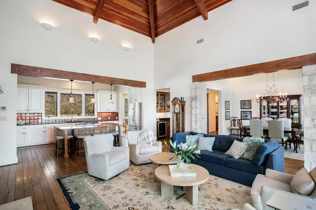 a living room with furniture a rug and a table