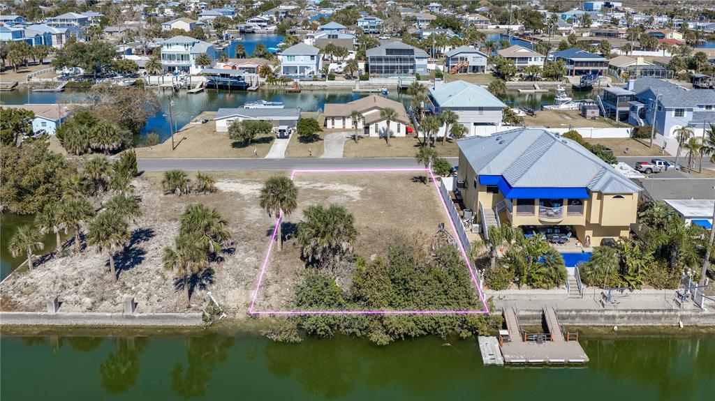 4348 Tahiti Drive Hernando Beach, FL 34607 - Photo 1 of 11 an aerial view of residential houses with outdoor space and swimming pool