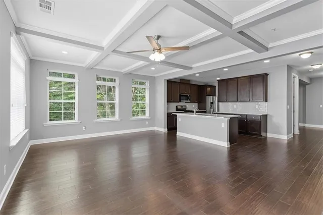 a view of kitchen with microwave a stove and wooden floor