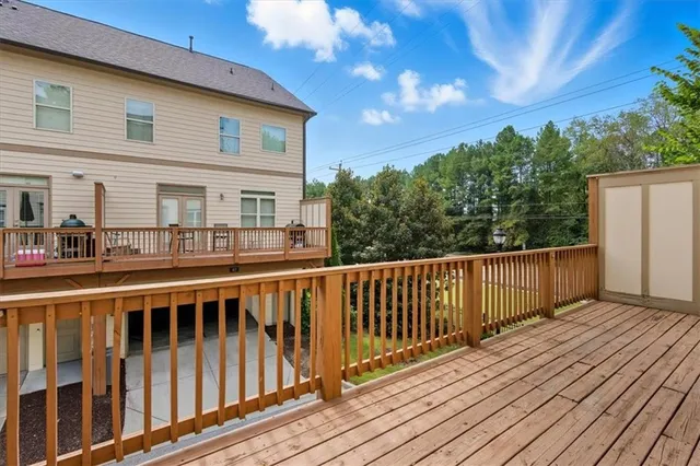 a view of a wooden deck and a yard with wooden fence