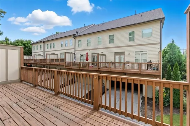 a view of a house with wooden deck