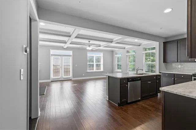 a large kitchen with kitchen island wooden floors and stainless steel appliances