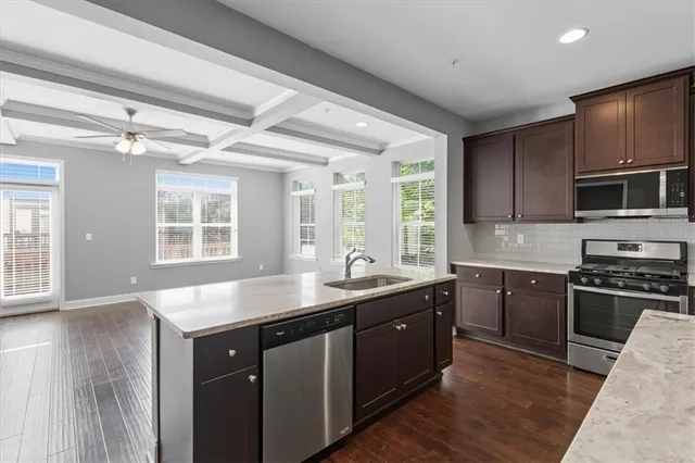 a kitchen with sink stove and microwave