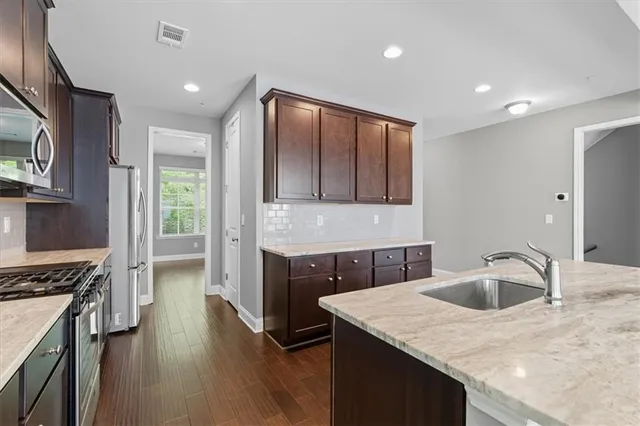 a kitchen with a sink stove and cabinets