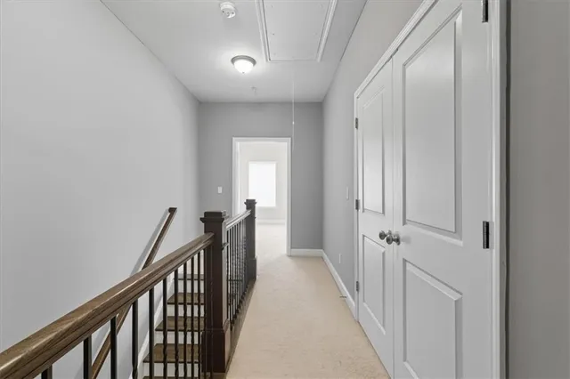 a view of a hallway with wooden floor and entryway
