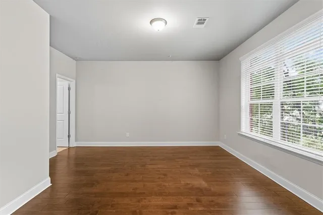 a view of room with window and wooden floor