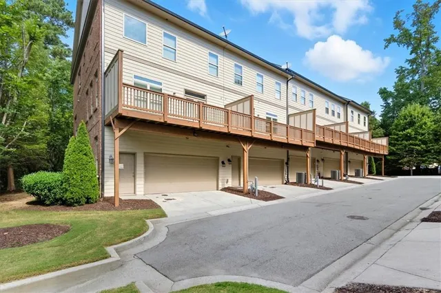 a front view of a building with a garden