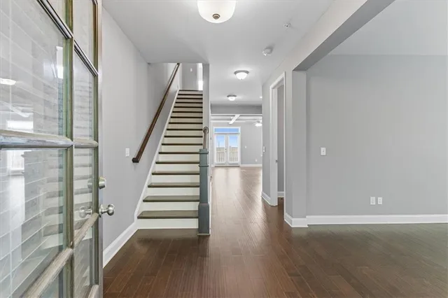 an entryway in a hall with wooden floor and entryway