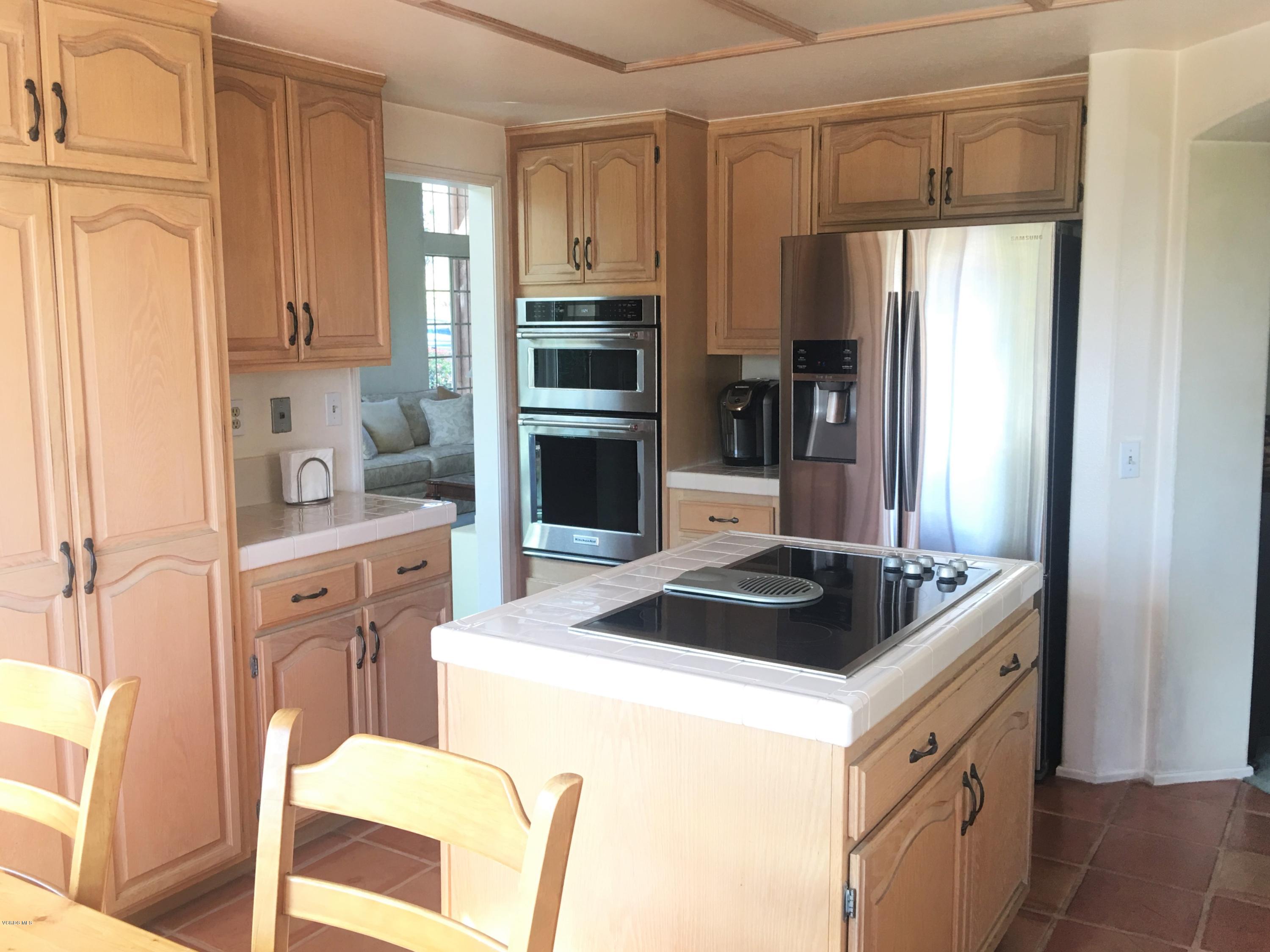 330 Innwood Road Simi Valley, CA 93065 - Photo 14 of 63 a kitchen with stainless steel appliances kitchen island granite countertop a sink stove and refrigerator