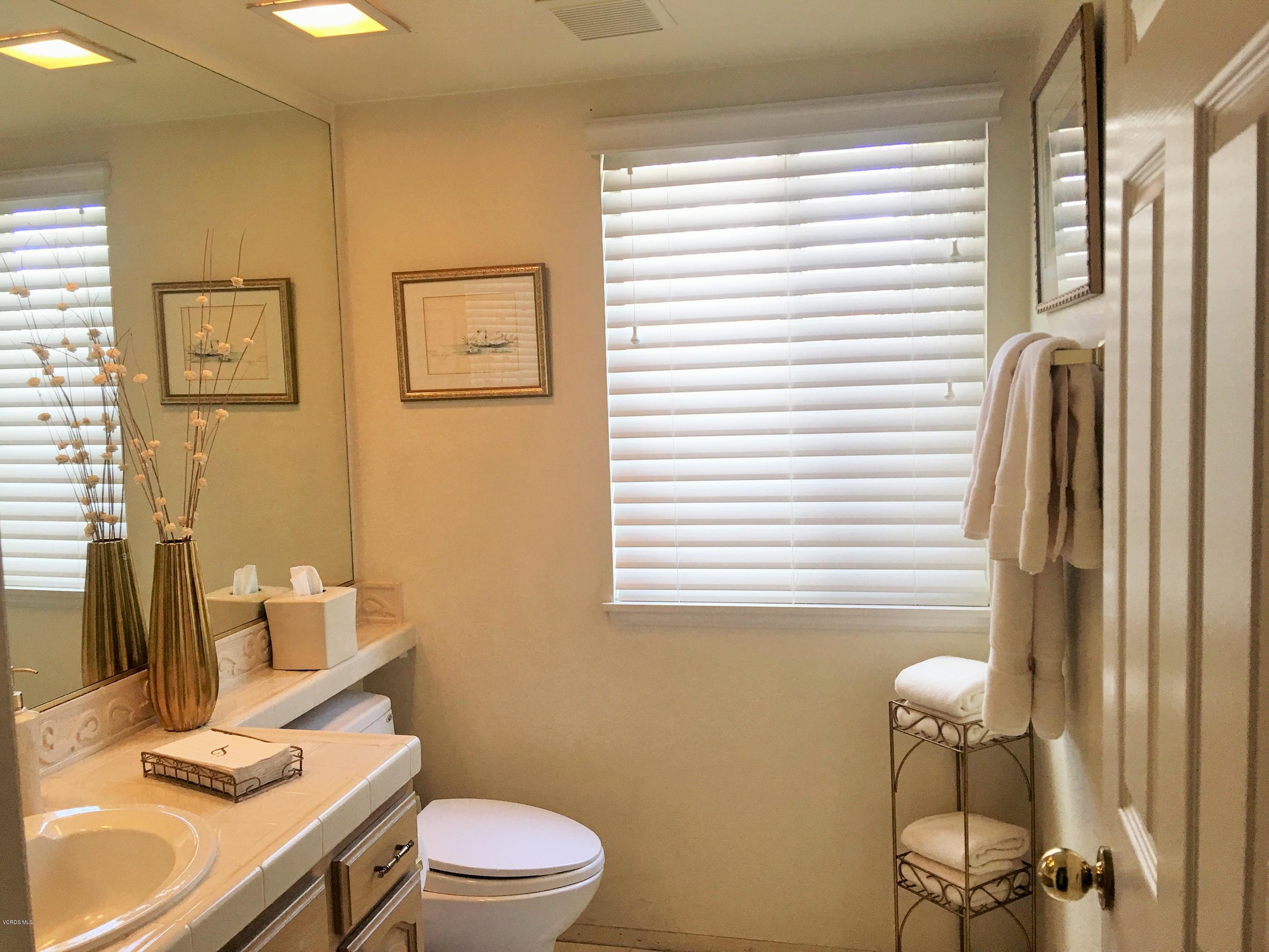 330 Innwood Road Simi Valley, CA 93065 - Photo 22 of 63 a bathroom with a granite countertop sink toilet and a mirror