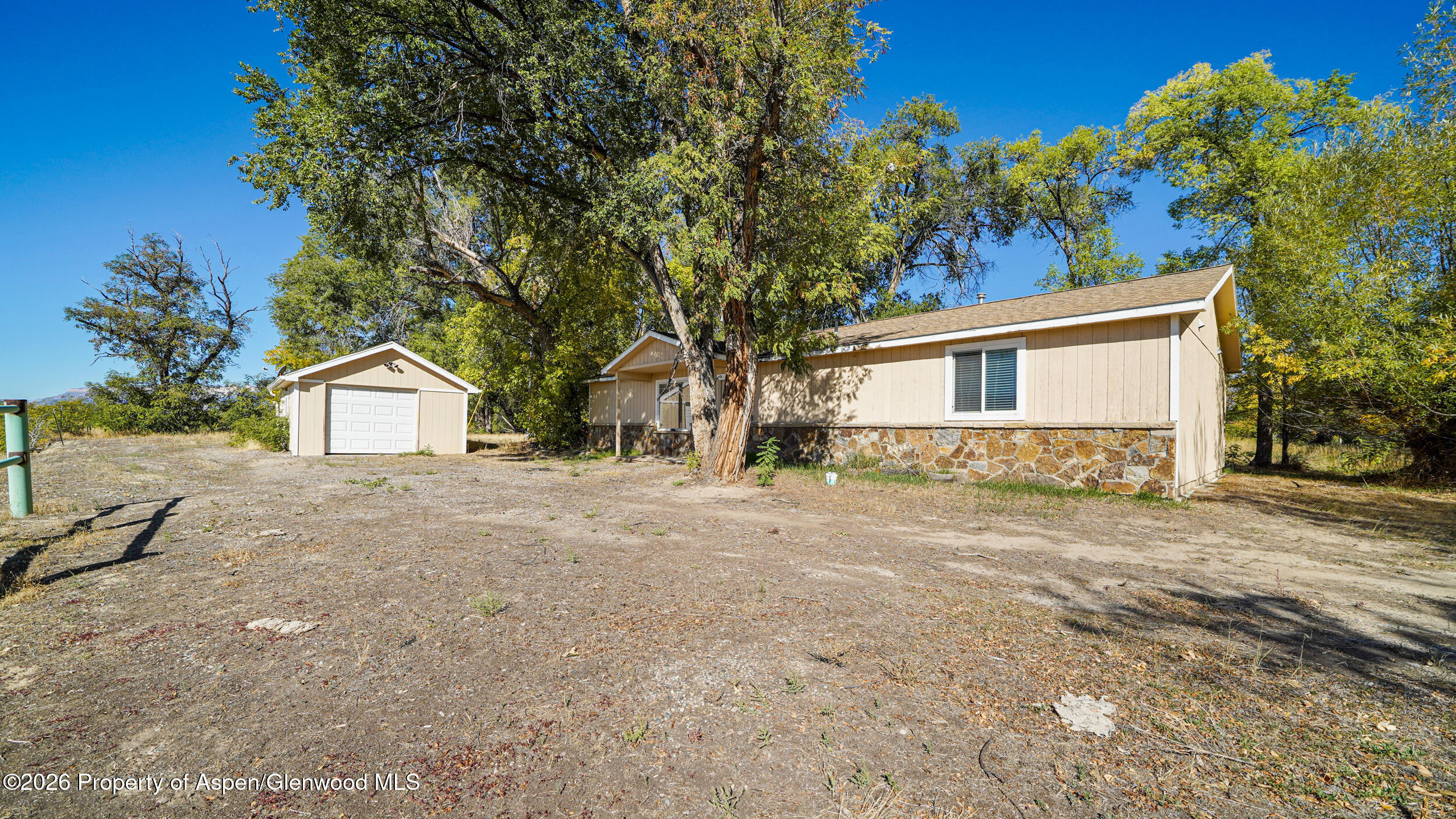 30412 Highway 6 Rifle, CO 81650 - Photo 19 of 24 a front view of a house with a yard and garage