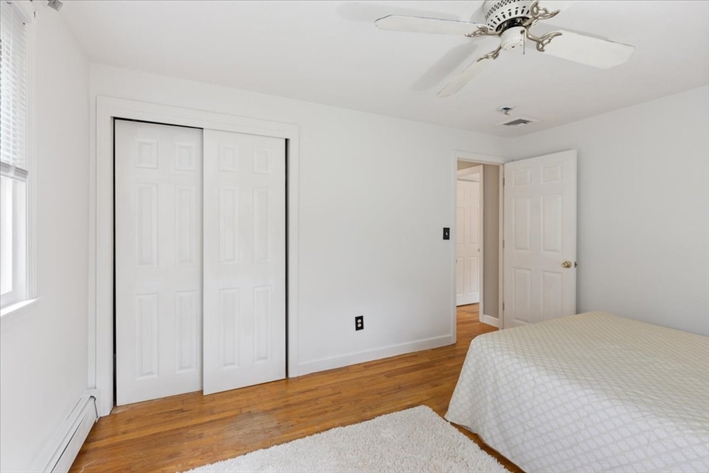 9 Georgia Drive Walpole, MA 02081 - Photo 19 of 42 a bedroom with a bed and a chandelier fan