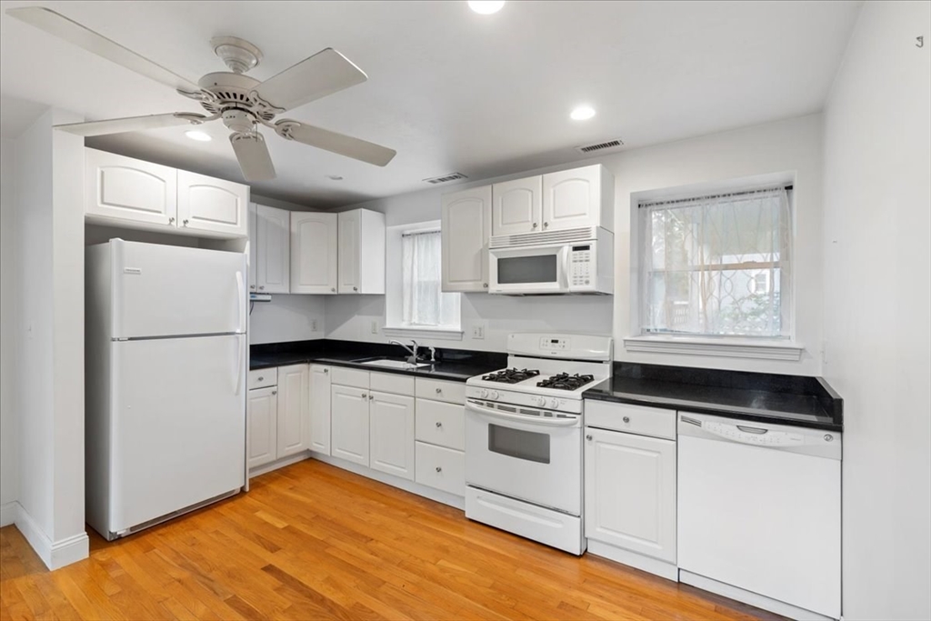 9 Georgia Drive Walpole, MA 02081 - Photo 30 of 42 a kitchen with a refrigerator stove and white cabinets