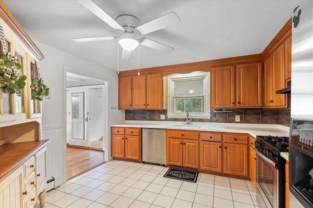 9 Georgia Drive Walpole, MA 02081 - Photo 8 of 42 a kitchen with a sink stove and cabinets