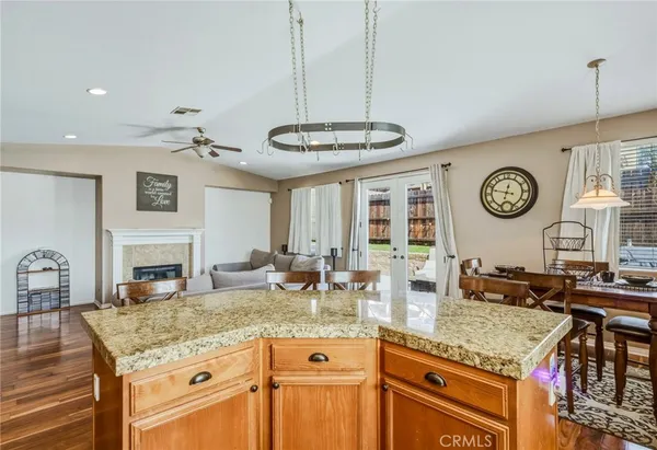 a kitchen with a counter space cabinets and a clock on the wall