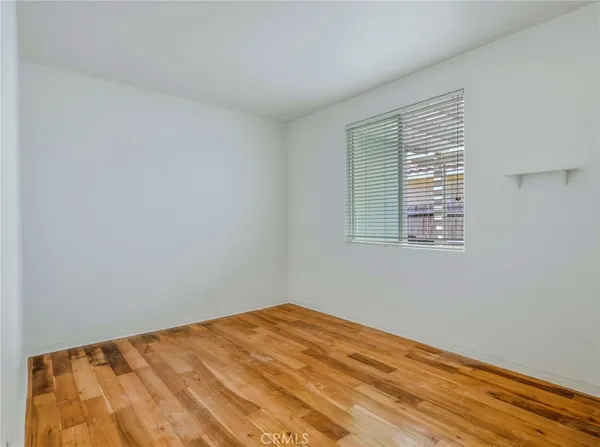 a view of a room that has a bed and a window