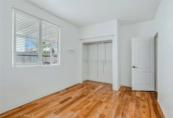 a bedroom with a bed and large window