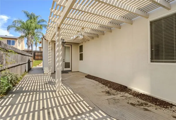 a backyard of a house with table and chairs
