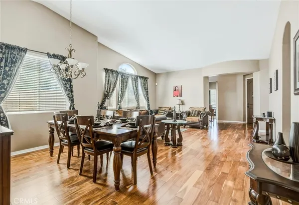 a view of a dining room with furniture and wooden floor