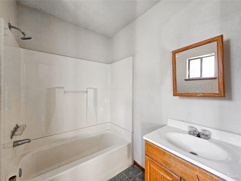 7706 North Jasman Road Edinburg, TX 78542 - Photo 13 of 15 a bathroom with a sink and a bathtub