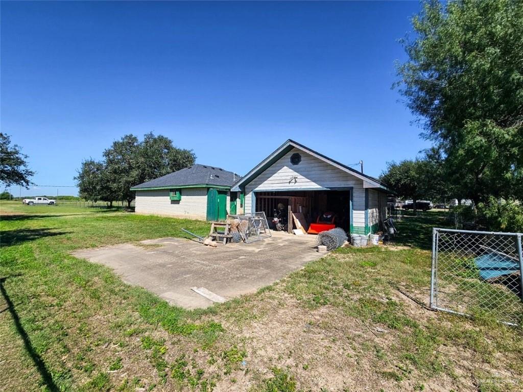 7706 North Jasman Road Edinburg, TX 78542 - Photo 15 of 15 a view of backyard with wooden fence and a large tree