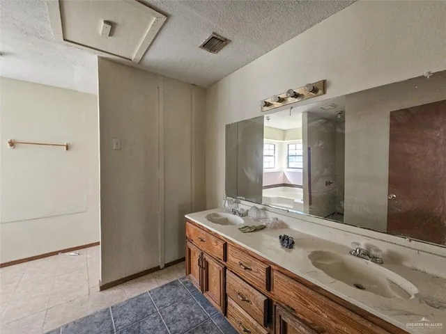 a bathroom with a glass shower door and a sink