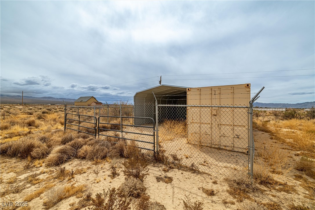 1411 West Harris Farm Road Pahrump, NV 89060 - Photo 19 of 25 View of outdoor structure featuring a gate and fence