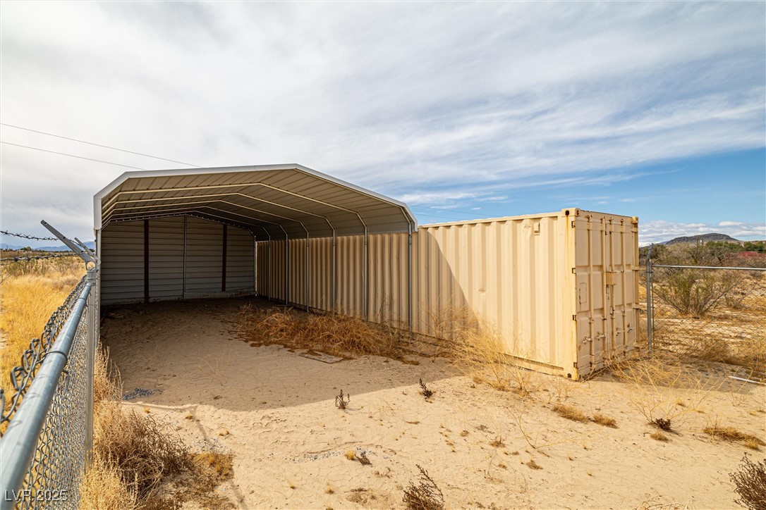 1411 West Harris Farm Road Pahrump, NV 89060 - Photo 20 of 25 View of outdoor structure with fence and a detached carport