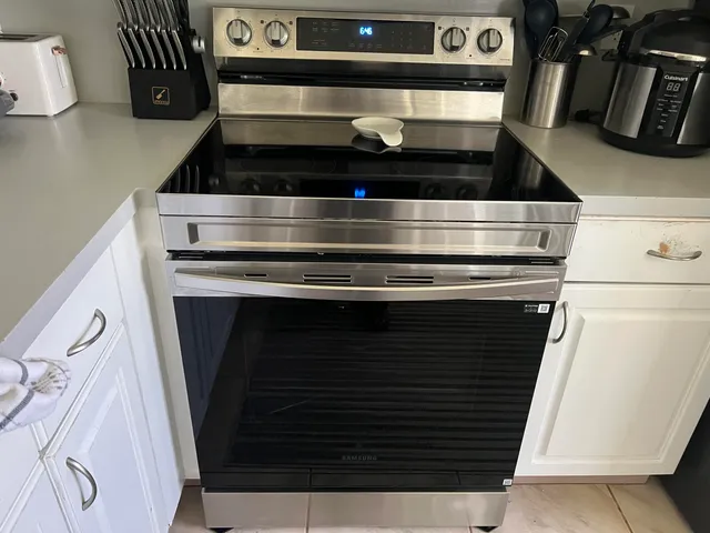 a kitchen with a refrigerator and cabinets