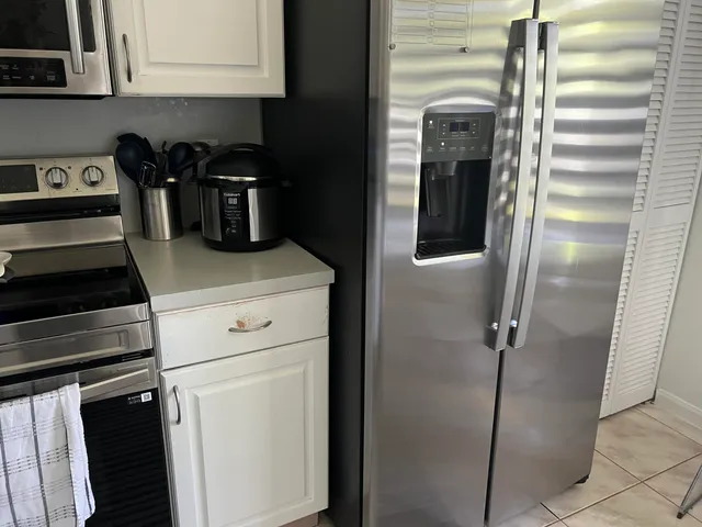 a view of a dining room with furniture and a chandelier
