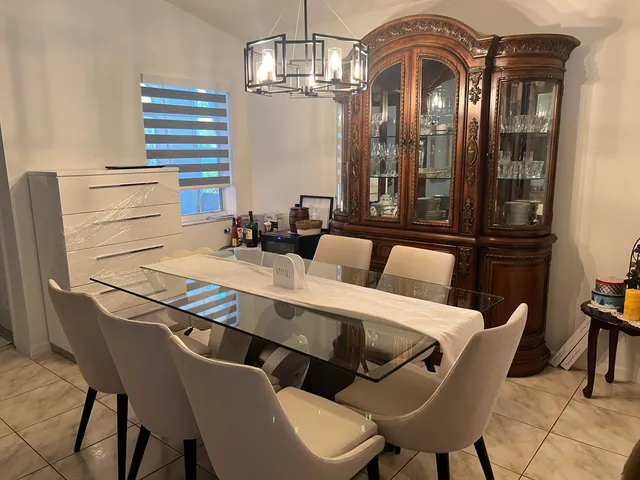 a living room with furniture potted plant and a large window