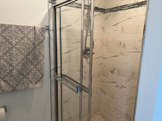a bathroom with a shower and toilet
