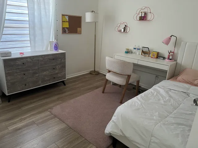 a bedroom with furniture and a large window