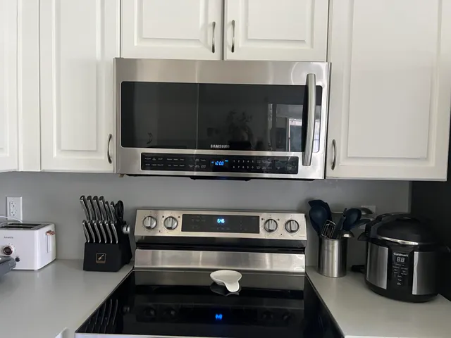 a kitchen with a sink stove and microwave
