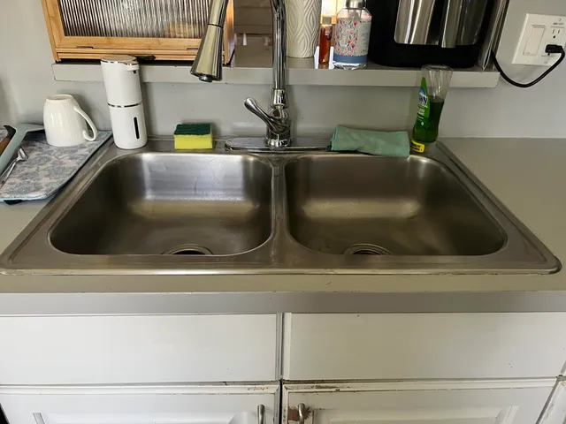 a stove top oven sitting inside of a kitchen